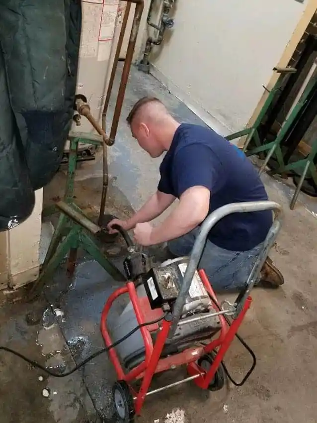 plumber working in commercial pipe drain cleaning, Commercial Plumbing Installation