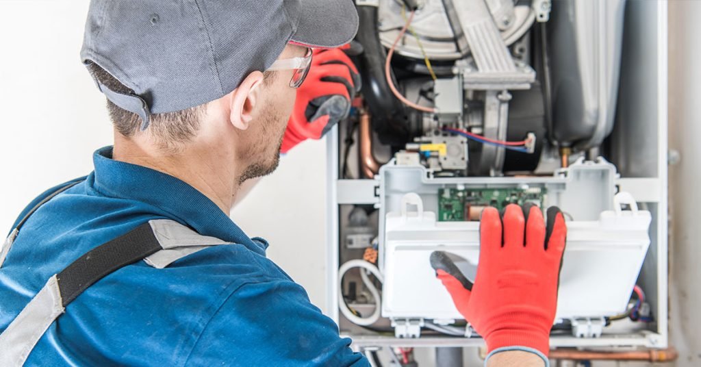 technician working in heating unit, Furnace Maintenance Columbia SC