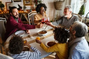 Ensure a Cozy Stay for Your Holiday Guests - Happy mulitethnic family having a holiday dinner together.